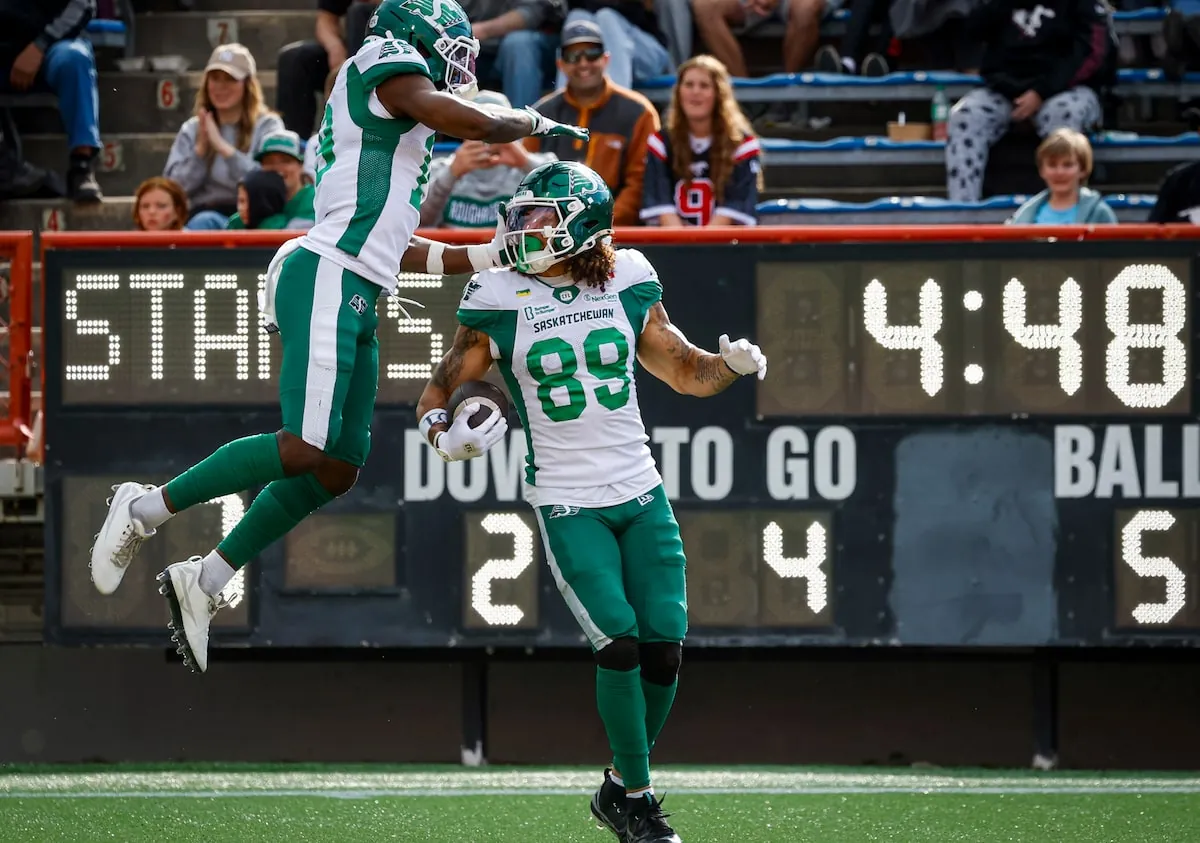 Saskatchewan Roughriders' receiver Kian Schaffer-Baker, right, celebrates his touchdown with Samuel Emilus during a game last month in Calgary against the Stampeders.Jeff McIntosh/The Canadian Press