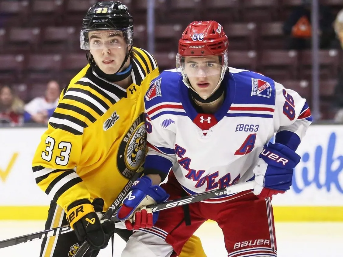 Sarnia Sting's Kaden Aucoin (33) leans on Kitchener Rangers' Luca Romano (86) at Progressive Auto Sales Arena in Sarnia, Ont., on Wednesday, March 4, 2026. Mark Malone/Chatham Daily News/Postmedia Network