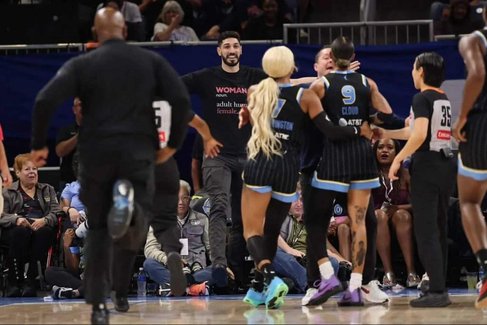 Former NBA player Enes Kanter Freedom and Chicago Sky guard Natasha Cloud yell at each other during a WNBA game.