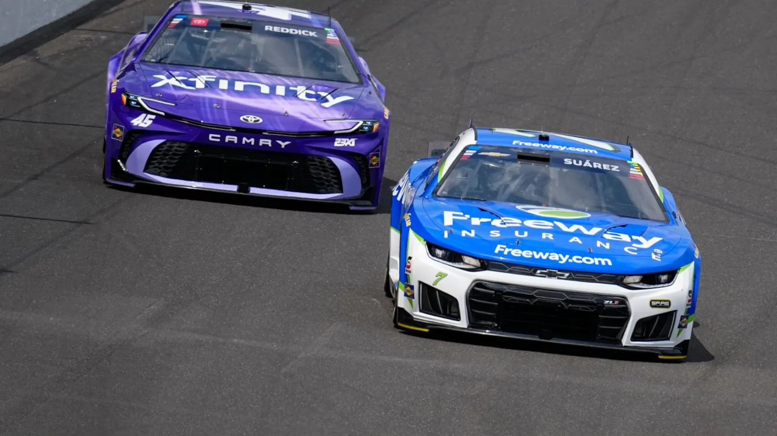 Daniel Suarez (7) leads Tyler Reddick (45) into the first turn during a NASCAR Cup Series auto race at Indianapolis Motor Speedway in Indianapolis, Sunday, July 26, 2026. (AP Photo/Michael Conroy)(Michael Conroy)