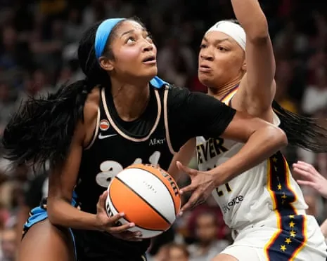 Angel Reese makes a move against an Indiana Fever defender during a game.